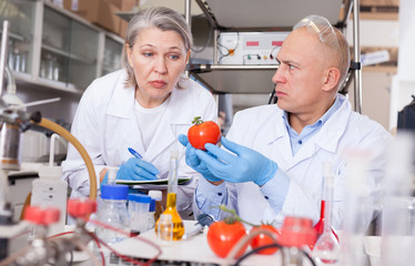 Biochemists recording experimental procedure and results