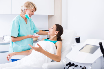 Cosmetician explaining treatment to patient