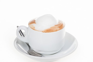 Full milk cup with spoon and plate