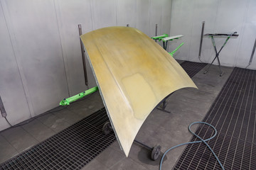 Painting and drying in a professional box of car body parts after applying putty and paint on...