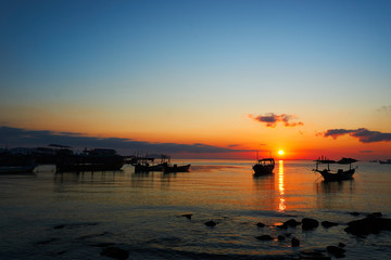 Beautiful sunrise on tropical beach Koh rong cambodia Landscape with longtail boats while sun is going up