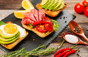 Healthy Breakfast. Sandwiches. Toasts with fried egg, salami and avocado