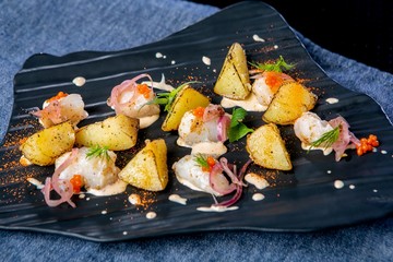 Smoked catfish and baked quince. European cuisine. The work of a professional chef. Dish from a restaurant or cafe menu. Close-up