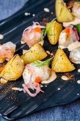 Smoked catfish and baked quince. European cuisine. The work of a professional chef. Dish from a restaurant or cafe menu. Close-up