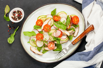 Fried chicken fillet and fresh vegetable salad .
