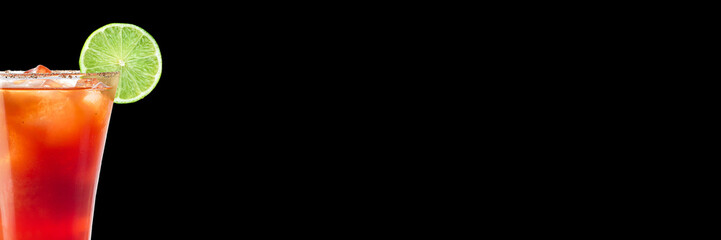 Delicious alcoholic trendy cocktail with tomato juice and lime on a black background. Wide format banner.