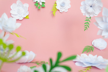 White paper flowers on pink background. Floral