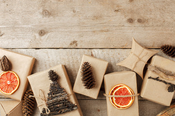 Set of gift box in craft paper with natural decoration on vintage wooden background, Gift holiday concept. Zero Waste lifestyle, border, copy space