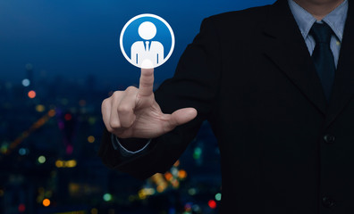 Hand click businessman flat icon over blur colorful night light city tower and skyscraper, Business communication concept
