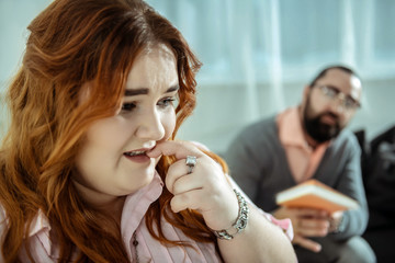 Close up of red-haired woman that touching mouth