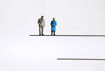 The concept of an aging society. Miniature people.