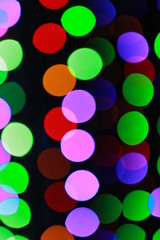 Background of colorful bokeh on dark. 