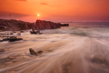 Fototapeta na wymiar Beautiful natural seascape wave hit the rock during sunset