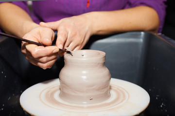 Modeling of clay on a potter's wheel In the pottery workshop
