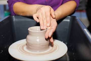 Modeling of clay on a potter's wheel In the pottery workshop