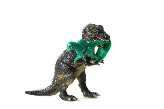 Plastic Dinosaur Fighting With A Toy Soldier