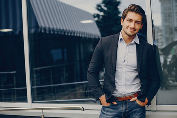 Man in a stylish suit. Businessman in a summer city