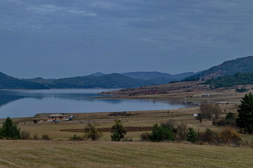 Obraz premium Amazing autumn view holiday village around Tsigov chark resort and Batak dam reservoir, Rhodope mountains, Bulgaria 