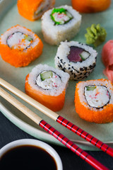 sushi rolls on black stone plate