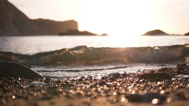 Golden sunrise over sparkly crystal water in Dorset UK