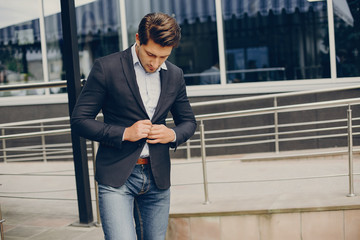 Man in a stylish suit. Businessman in a summer city