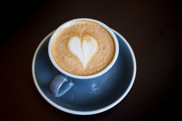Fototapeta na wymiar Coffee latte art with heart shape