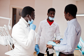 African american male doctor talking the sentence to the patient.