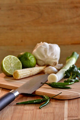 Thai vegetables on a wooden board with knife