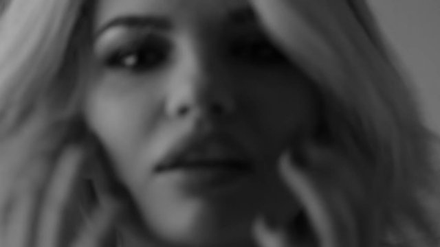 Blurred video. Closeup portrait of a beautiful girl. Black and white video.