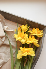 bouquet of yellow daffodils on wooden table