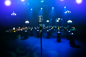 stylish 50s or 60s retro rock microphone on an empty venue stage. Vintage mic at a live band show