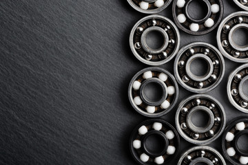 Frame of various ball bearings with free space. Technology and machinery industrial background.
