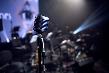 stylish 50s or 60s retro rock microphone on an empty venue stage. Vintage mic at a live band show