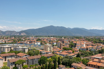 Fototapeta na wymiar Panoramic view of Pisa city with historic buildings and far away mountains