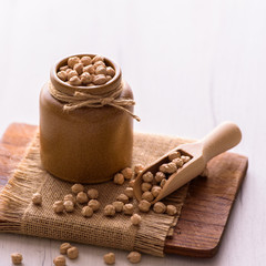 Portion of Chick Peas in ceramic bowl on table. Natural vegan food.