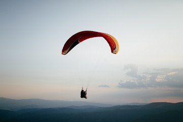 Hang glider pilot in mountains