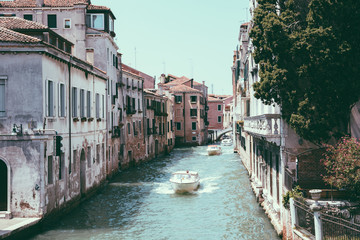 Panoramic view of Venice narrow canal with historical buildings and boats