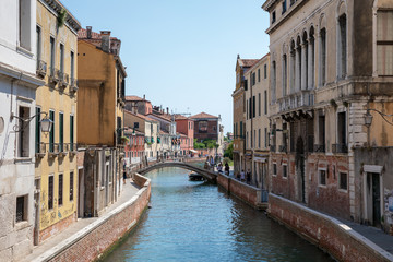 Panoramic view of Venice narrow canal with historical buildings and boat