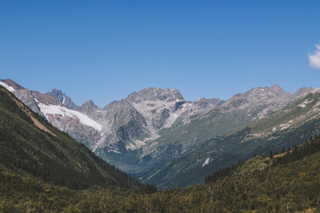 Fototapeta premium Panorama view of mountains scenes in national park Dombay, Caucasus