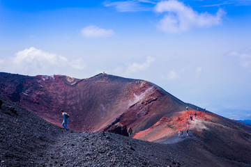 People walking on Mount Etna, active volcano on the east coast of Sicily, Italy.