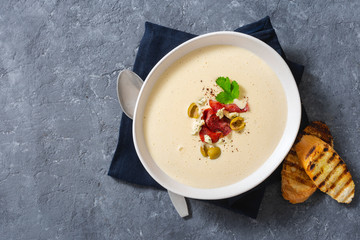 Bowl cheese soup bacon olives top view copy space