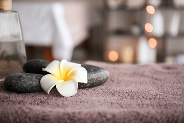 Fototapeta na wymiar Massage stones on table in spa salon