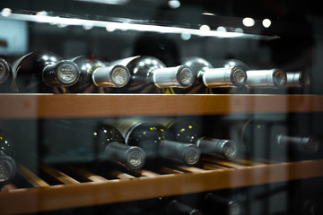 Fototapeta Storing bottles of wine in fridge. Alcoholic card in restaurant. Cooling and preserving wine. obraz
