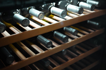 Storing bottles of wine in fridge. Alcoholic card in restaurant. Cooling and preserving wine.