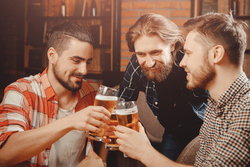 Old friends, guys having fun and drinking draft beer in pub. Concept male friendship, meeting