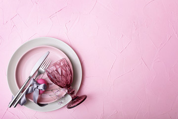 Beautiful Easter table setting on color background