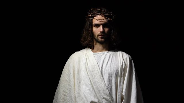 Jesus in crown of thorns and robe giving hand, asking for belief and kindness