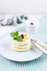 Homemade cheese pancakes on a white plate