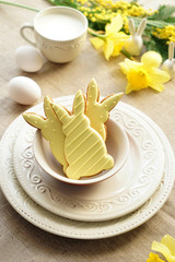 Plates with tasty Easter cookies on table