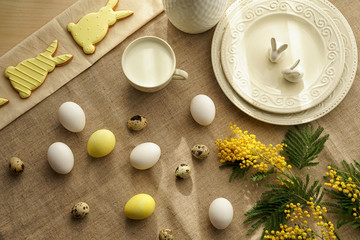 Fototapeta na wymiar Tasty Easter cookies with milk and eggs on table